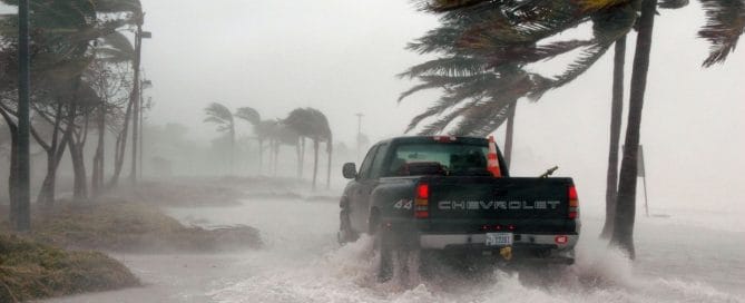 Inspection crews driving through a storm, highlighting the need for new ROV inspection technology for pre-storm checks in Florida.