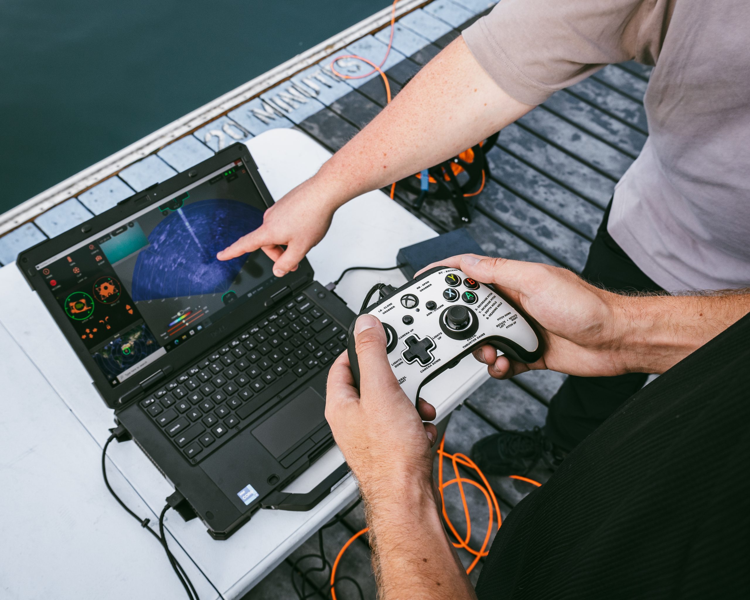 ROV pilots operating the SRV-8 ROV with imaging sonar for inspection work on a dockside. 