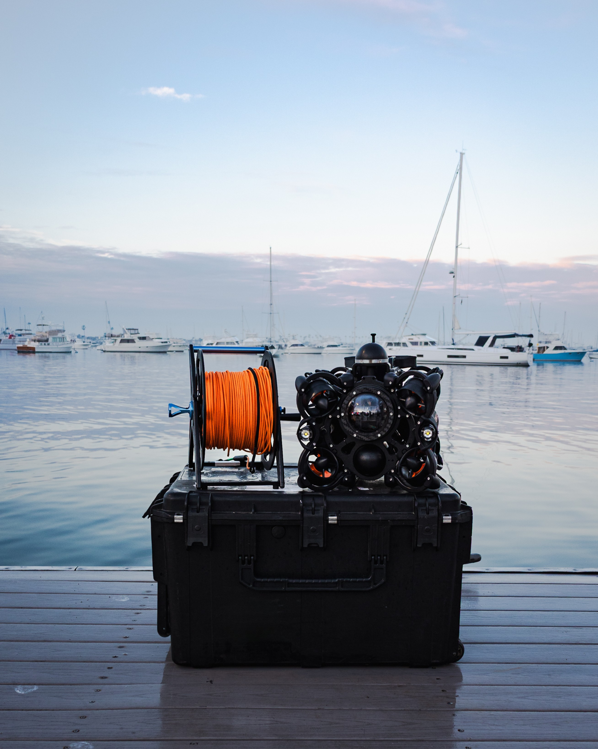 SRV-8C Tether and Portable Case SRV-8C ROV sitting on top of its compact transport case next to the orange rugged tether.