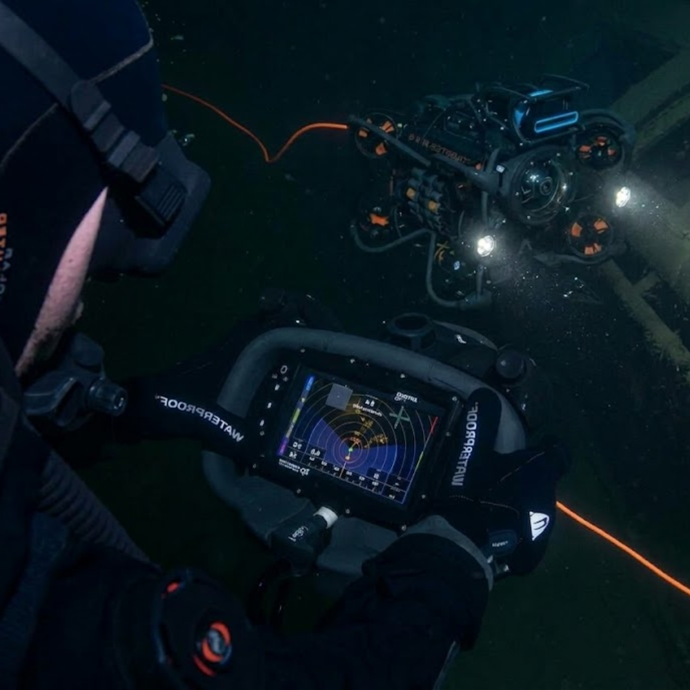 Military combat divers utilizing the Artemis HHC to operate the SRV-8 remotely operated vehicle (ROV).